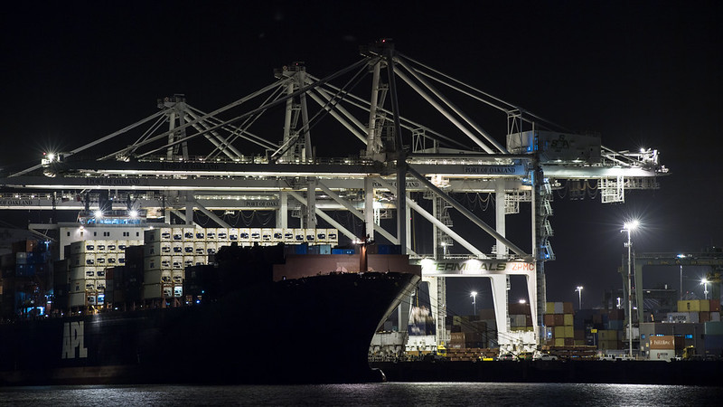 Container ships at the Port of Oakland, in Oakland, CA are unloaded and loaded during the evening of December, 30, 2016.