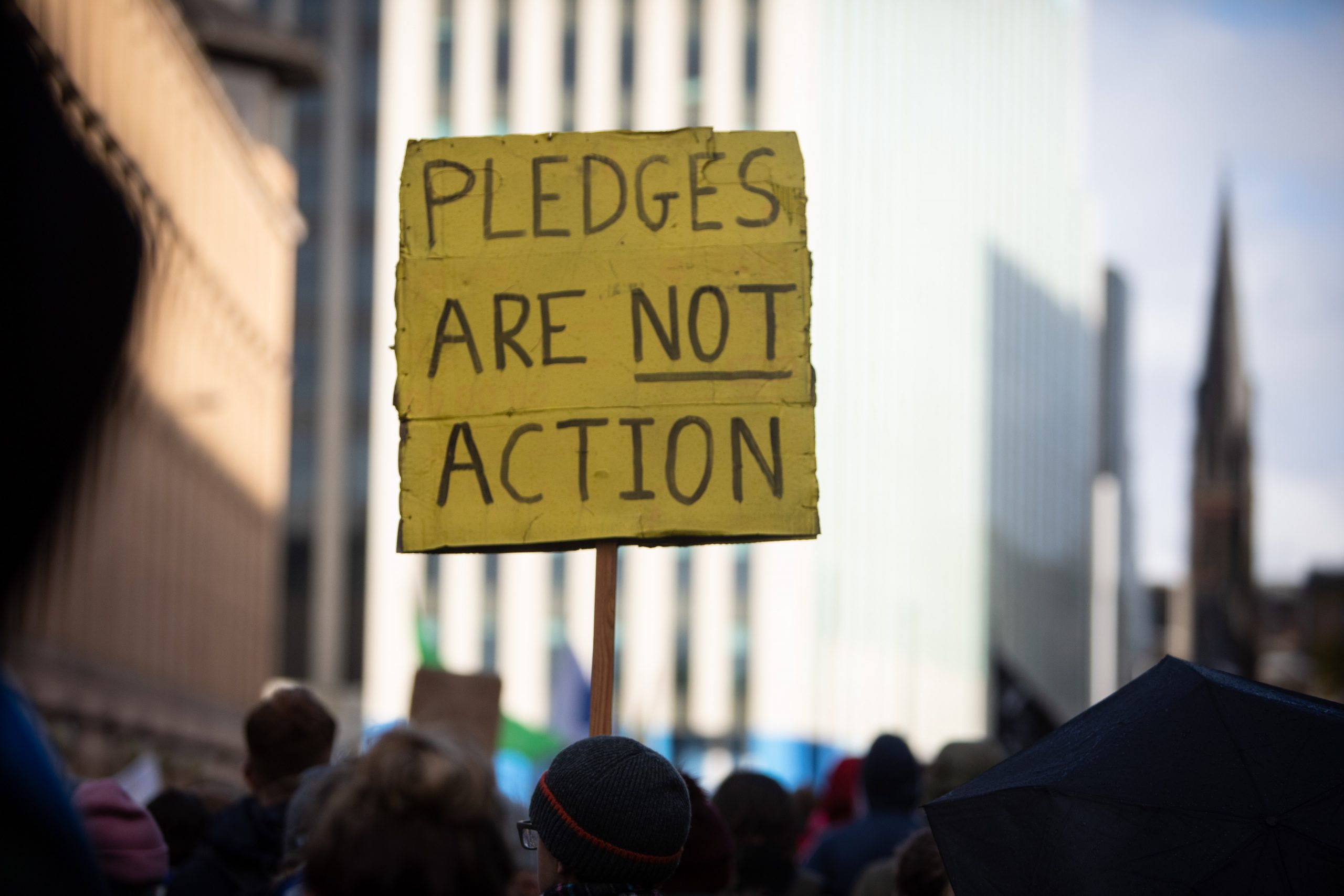 Iris Cheng (holding banner), of Taiwan - Global Day of Action, march through the streets of Glasgow, Scotland, UK, on 6th Nov 2021.