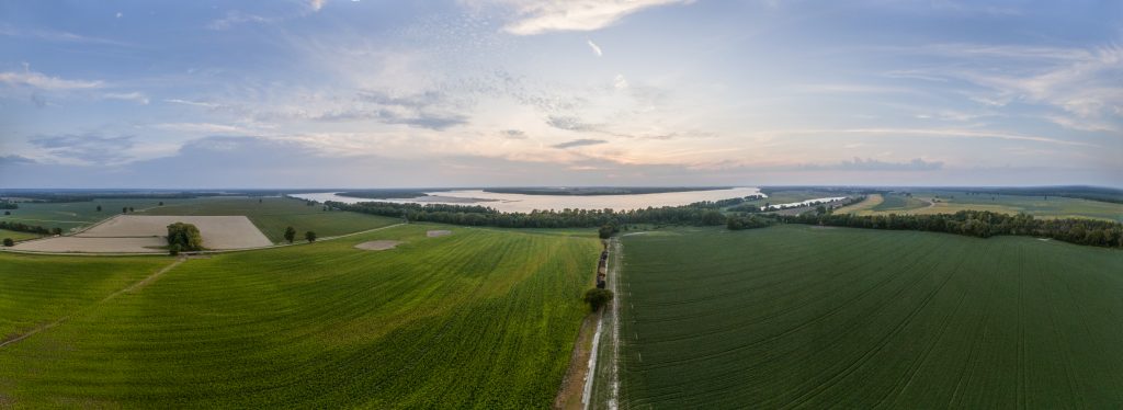 Aerial panorama of the Mississippi River flows in the distance and it is not uncommon to see water flood the fields in the foreground where Charlie Roberts, owner of Roberts Farms focuses on utilizing conservation practices developed with the U.S. Department of Agriculture (USDA) Farm Production and Conservation (FPAC) Natural Resources Conservation Service (NRCS) to utilizes cover crops to prevent sheet, rill, and ephemeral gullies; and implementing soil health principals that improve soil health of his land, in Lauderdale County, TN, on Sept 20, 2019. Cover crops have helped stabilize and hold the soil in place when waters flow over the fields.