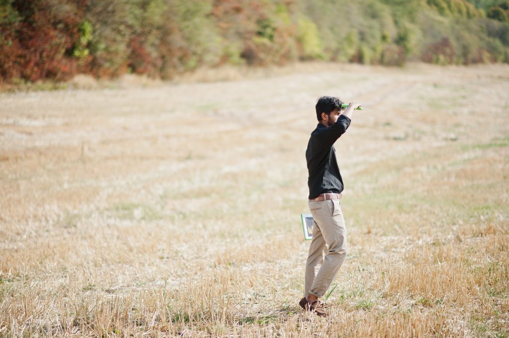 South Asian agronomist farmer inspecting wheat field farm. Copyright: ASphotofamily/Freepik.