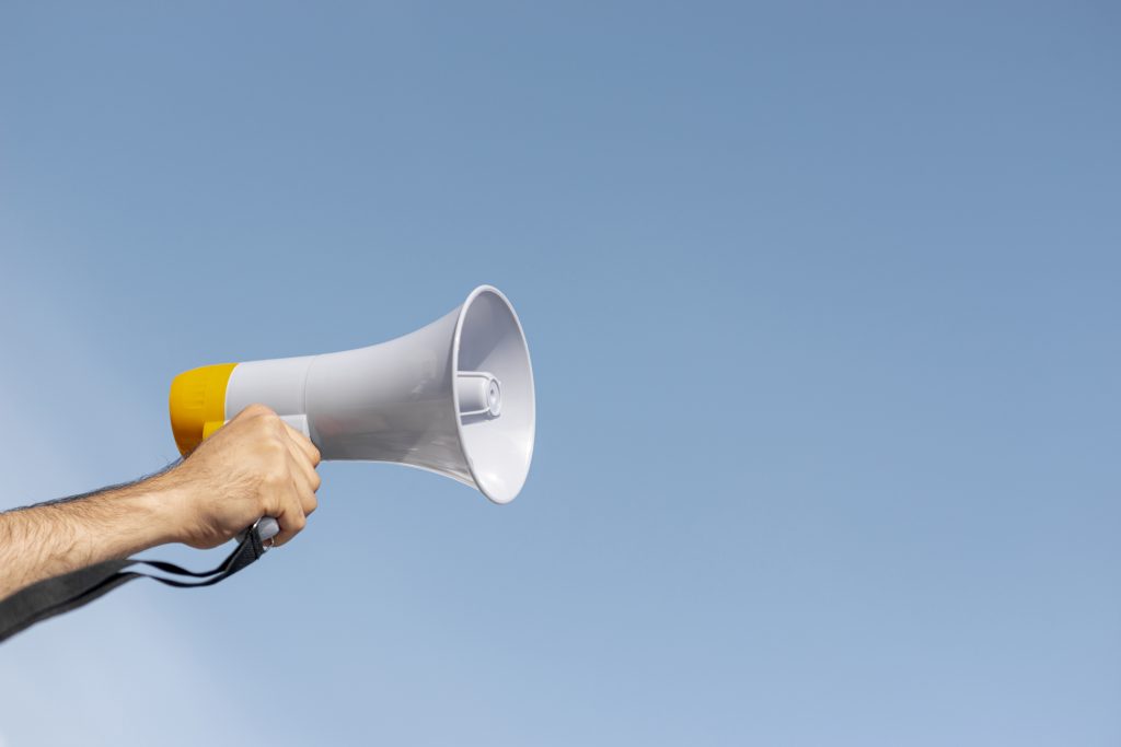 protester-holding-megaphone-demonstration. Copyright: Freepik.